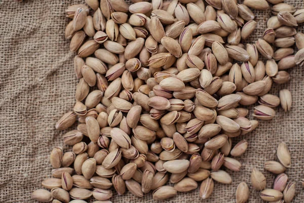 Pistachios on burlap sack. Healthy food high protein. Dietary nutrition. close-up. flat lay