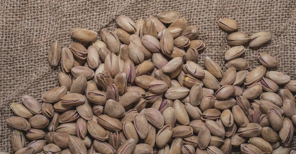 Pistachios on burlap sack. Healthy food high protein. Dietary nutrition. close-up. flat lay
