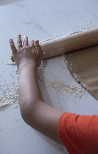 a little boy 6 years old rolls out dough with a rolling pin.cooking concept