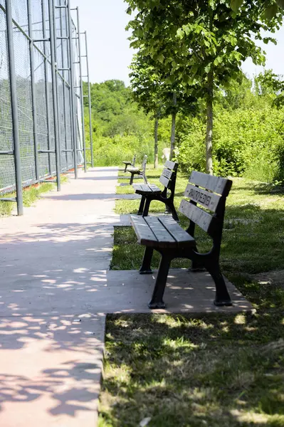 stock image Bench in the park near the playground.