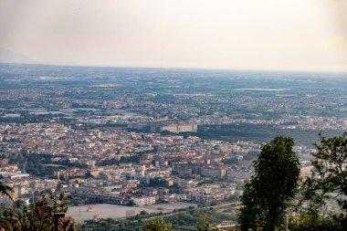 A breathtaking panoramic view of the city of Caserta, Italy, with the iconic Royal Palace standing out amidst the urban landscape. The photo captures the harmony between the historical grandeur of the palace and the modernity of the surrounding city clipart