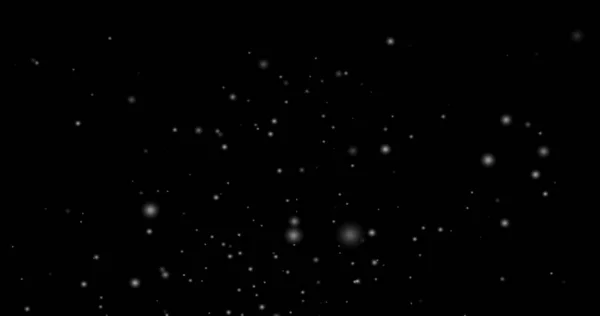 Cinematic snowfall loop animation of a surreal realistic snowflake falling bg. Snowfall winter overlay slowly falling motion graphic on a black backdrop.Snow flake for Christmas new year 2026,2025.