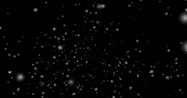 Cinematic snowfall loop animation of a surreal realistic snowflake falling bg. Snowfall winter overlay slowly falling motion graphic on a black backdrop.Snow flake for Christmas new year 2026,2025.