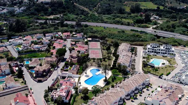 stock image Aerial flyover of architecturally-designed modern prestige homes with pools in outer suburban Estepona, Spain. High quality 4k footage