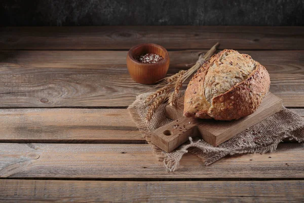 新鲜的烤全麦面包 用燕麦 亚麻籽和芝麻籽放在乡村木木板上 面包店产品 — 图库照片