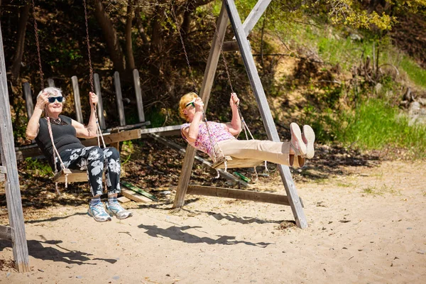 Two Elderly Women Joyfully Swinging Swing Having Fan Happy Retirement — Stok fotoğraf