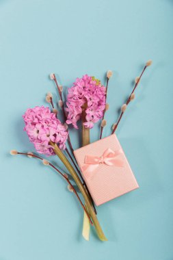 Mothers or Womens Day mock up card from spring hyacinth and iris flowers. Greeting card with empty place for text for International Mothers Day on blue background