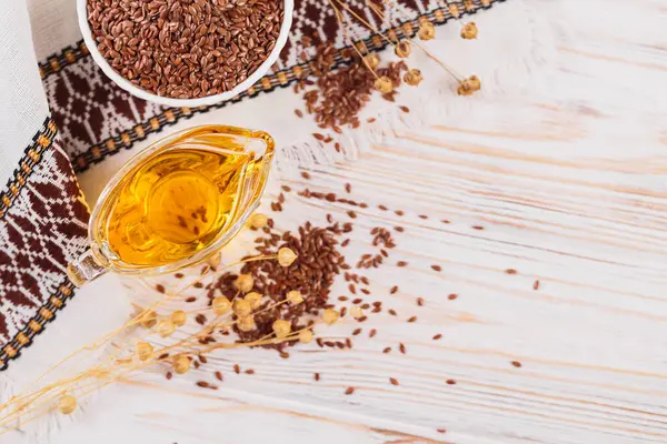 Kahverengi keten tohumu, keten tohumu sebze yağı, beyaz kırsal ahşap arka planda. Sağlıklı süper yiyecek üst görünümü, fotokopi alanı ile düz yatış