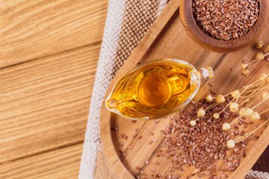 Kahverengi keten tohumu, kırsal ahşap arka planda keten tohumu sebze yağı. Sağlıklı süper yiyecek üst görünümü, fotokopi alanı ile düz yatış