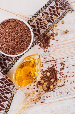 Kahverengi keten tohumu, keten tohumu sebze yağı, beyaz kırsal ahşap arka planda. Sağlıklı süper yiyecek üst görünümü, düz yatış