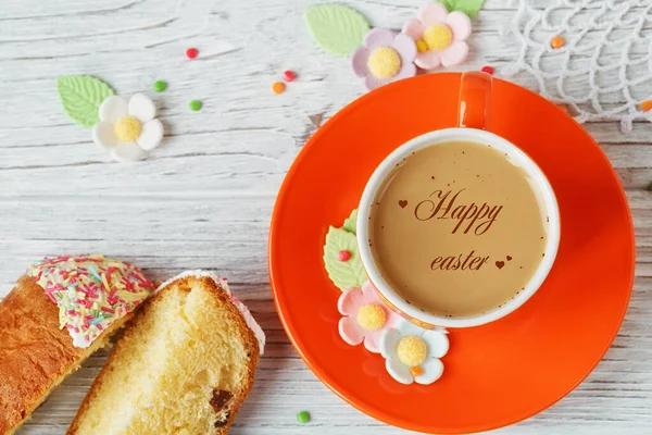 Holiday greeting card with Happy Easter text and hearts. Festive morning coffee and easter cake. Top view, flat lay