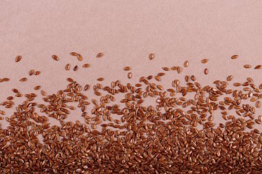 Bej arka planda kahverengi keten tohumları. Keten tohumu geçmişi. Sağlıklı süper yiyecek üst görünümü, fotokopi alanı ile düz yatış