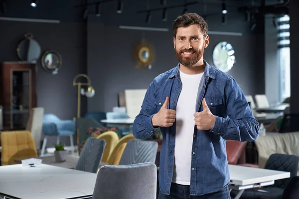 Handsome Bearded Man Showing Thumb Recommending While Standing Furniture Store — Stock Photo, Image