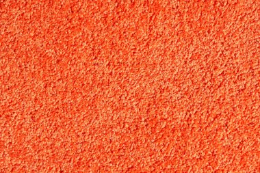 Turuncu doymuş, yumuşak yün halı dokusu. Yapay yün kumaş parçalı tüylü halıyı kapatın. Doku ve arkaplan kavramı.