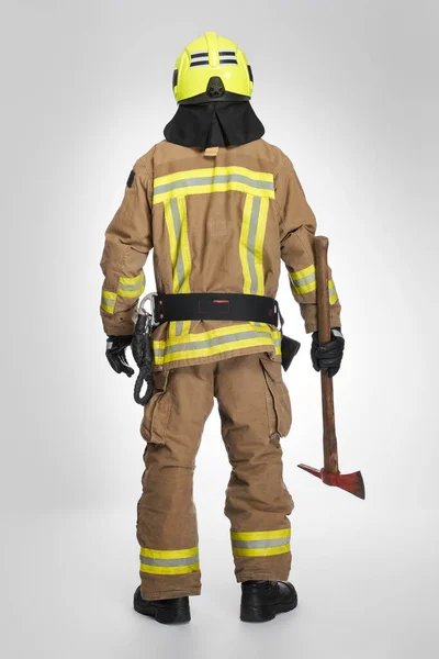 Strong Firefighter Helmet Uniform Holding Fire Axe Studio Back View — Stock Photo, Image