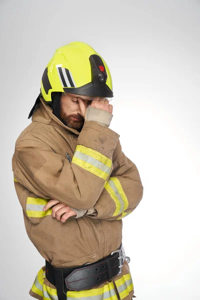 Sad Exhausted Firefighter Uniform Tiredly Rubbing Forehead Studio Side View — Stock Photo, Image