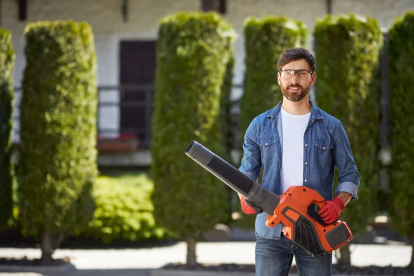 Strong Attractive Man Safety Glasses Posing Modern Cordless Leaf Blower Royalty Free Stock Photos