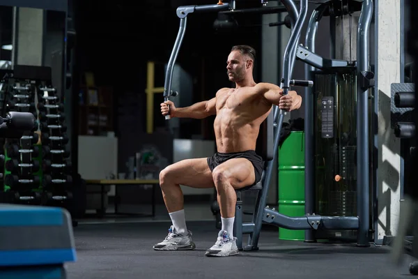 Strong Shirtless Athlete Sitting While Training Crossover Machine Gym Side Stock Picture