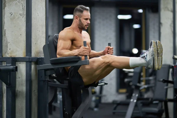 Handsome Sportsman Hairstyle Pulling Legs Working Out Indoors Full Body Royalty Free Stock Photos