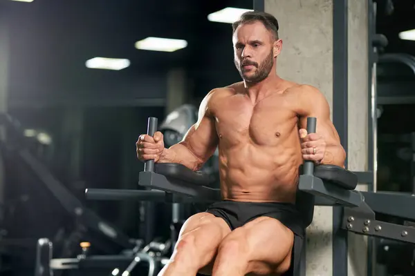 Handsome Bearded Sportsman Pulling Raising Legs Working Out Indoors Front Stock Image