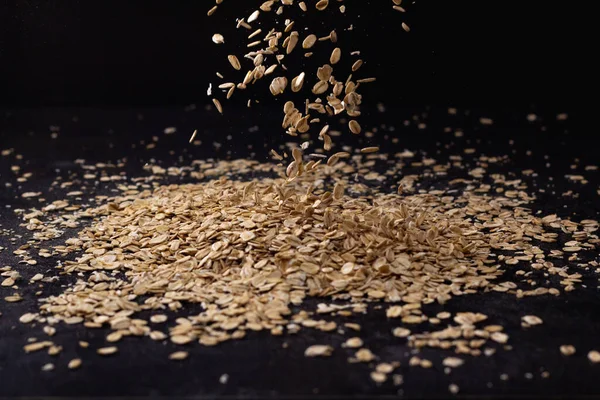 Stock image Falling oatmeal on wooden background