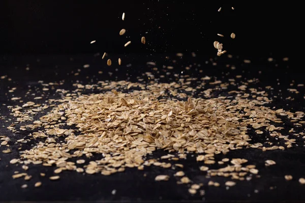 stock image Falling oatmeal on wooden background