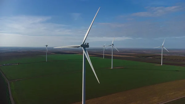 stock image Wind turbines standing in the field from the drone point of view