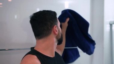 Banyoda tıraş olan bir adam işe hazırlanıyor.