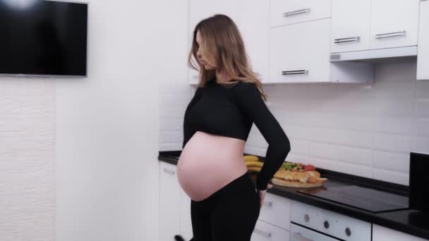 Expectant Mother Putting Pregnancy Belly Band Feel More Comfortable Third — Wideo stockowe
