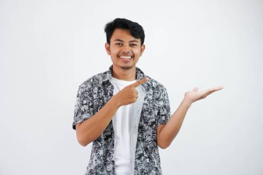 smiling asian man with an open hand with fingers pointing to the side wearing black shirt isolated on white background
