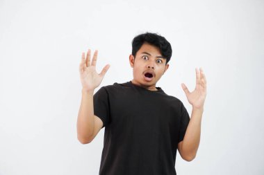amazed or shocked young asian man open hand with open mouth wearing black t shirt isolated on white background