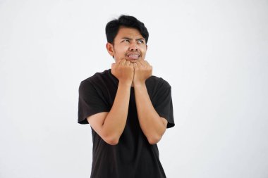 scared young Asian man black t shirt gesture afraid something isolated on white background