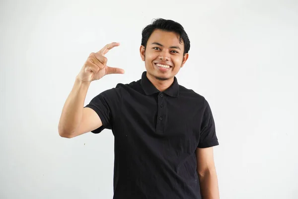 Ung Asiatisk Man Poserar Vit Bakgrund Hålla Något Litet Med — Stockfoto