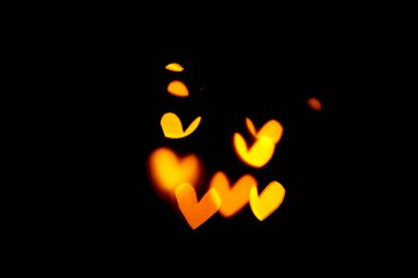 Bulanık bokeh kalpler altın, sarı renkler siyah arkaplanda