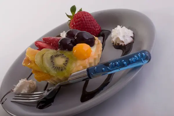  dessert with a tart fruit and chocolate on a plate