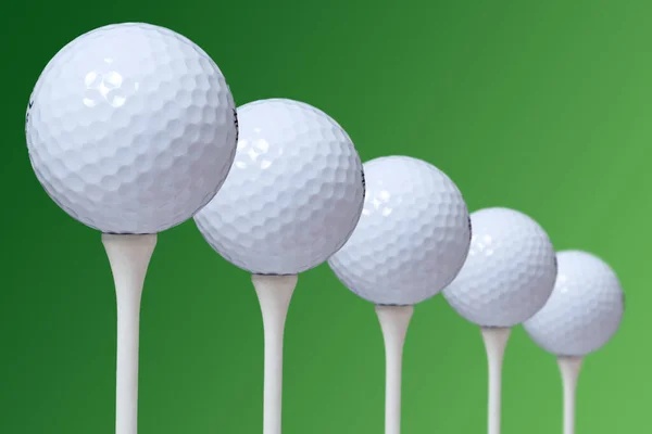 Closeup Five Golf Balls Tees Green Background — Stock Photo, Image