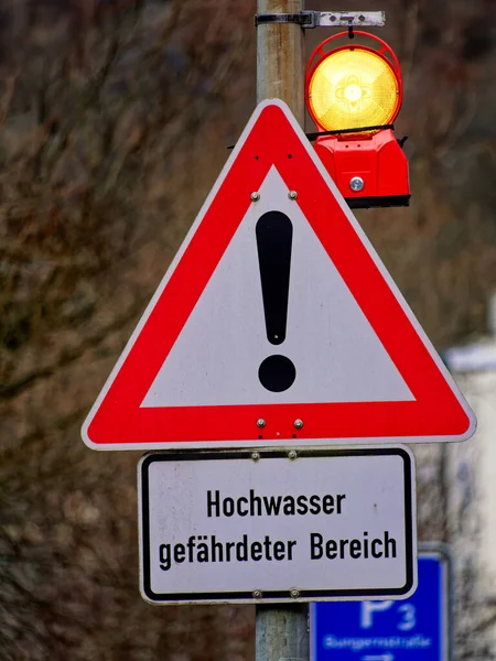Warning sign for an area at risk of flooding on the Lenne river in Altena, Germany