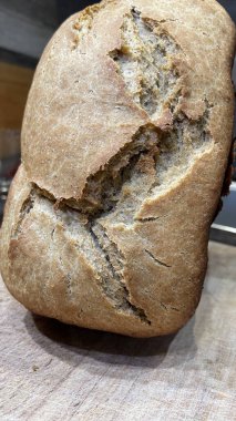 Siyah bir yüzeyde haşhaş tohumlu ev yapımı ekmek. 