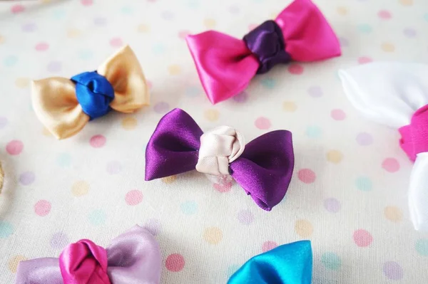 stock image Colorful bow tie on white fabric with polka dot background.