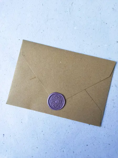 Envelope with wax seal on a white background, top view