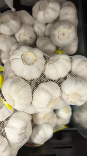 Markette içi taze sarımsak soğanıyla dolu bir poşetin yakın çekimi..