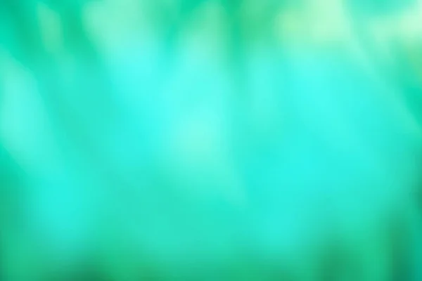Defocused aqua color background. Green jade blurred background with sun bokeh.