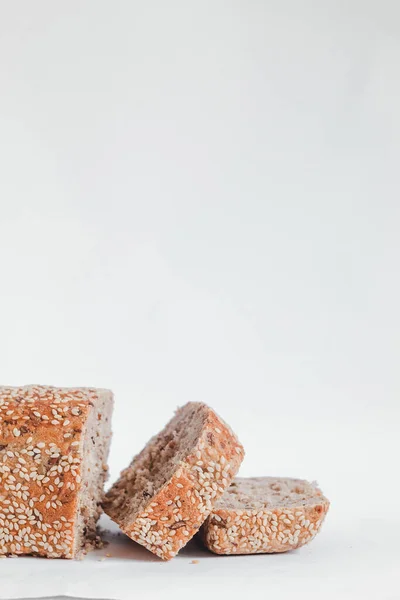 stock image Sliced sesame bread on a wooden board. Copy space.