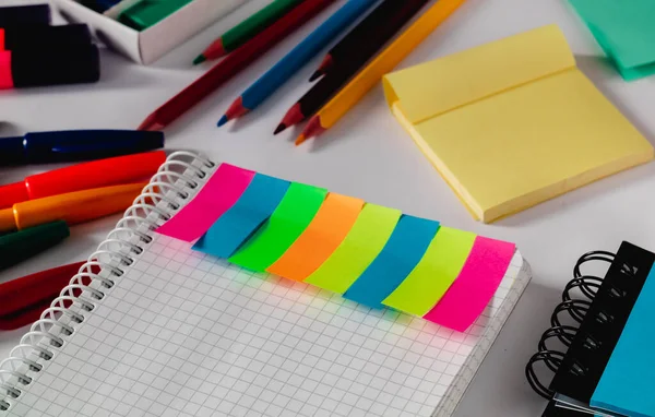 Open notebook with colored stickers and school tools. School concept.