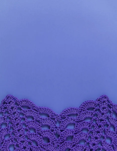 Purple seamless crochet texture with holes. Crochet arcade stitch. Top view. Copy space.