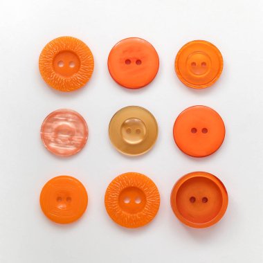 Orange plastic buttons on a white background. Sewing tools. Top view.
