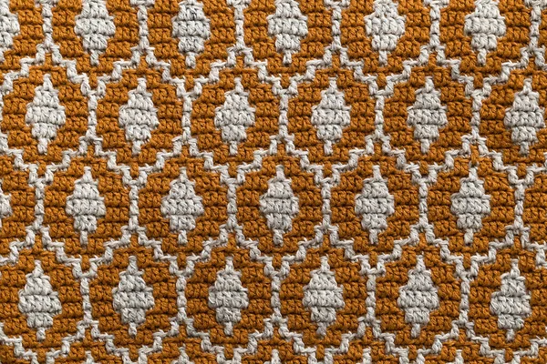 Yellow white mosaic crochet texture. Ellipse shaped repeating pattern. Knitted background.