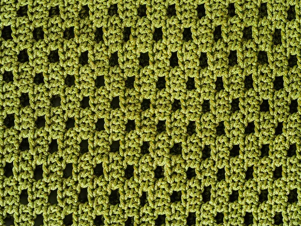 Yellow crochet pattern. Simple knitting mesh pattern. String knitted background.