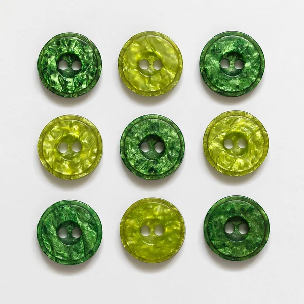 stock image Collection of green plastic buttons close up on a white background.