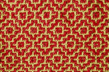 Sarı kırmızı geometrik etnik desenli örülmüş doku. Tığ işi mozaik desen. Rhombus ve kare desen.